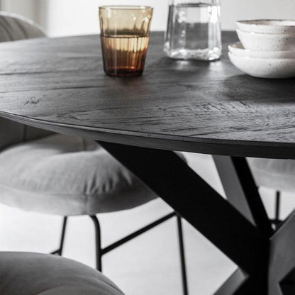 Ronde eettafel zwart teakhout met kruisende ijzeren poten